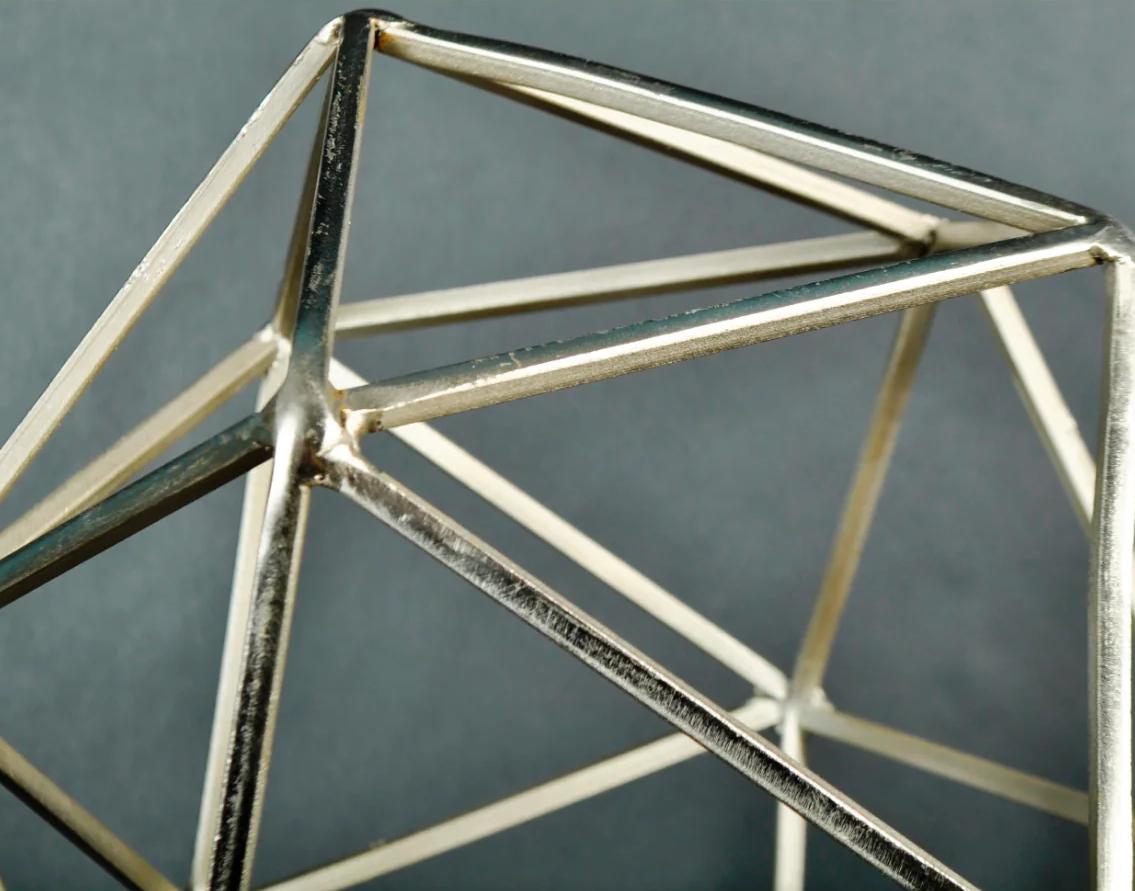 Metal sculpture on wood stand