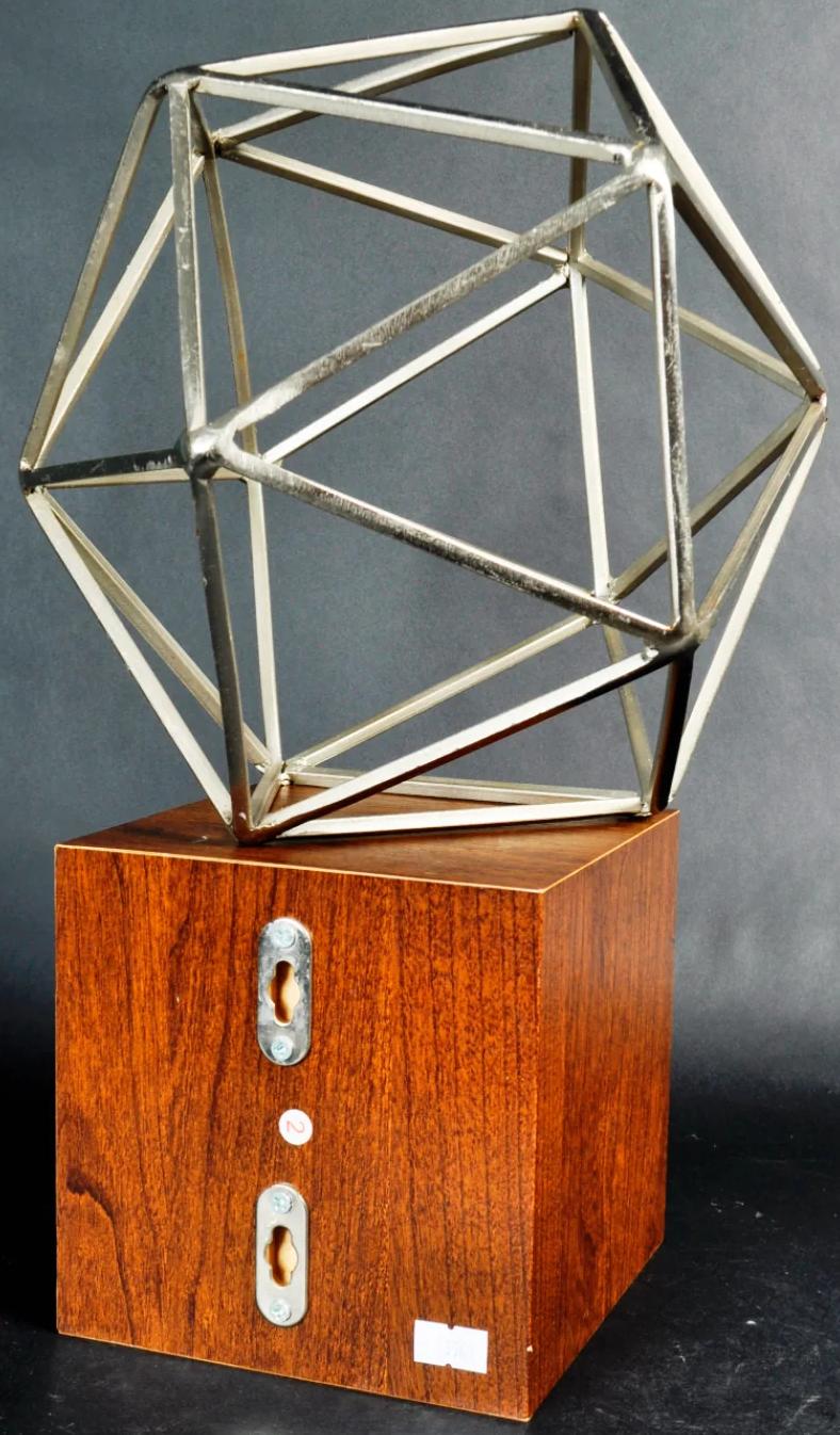 Metal sculpture on wood stand