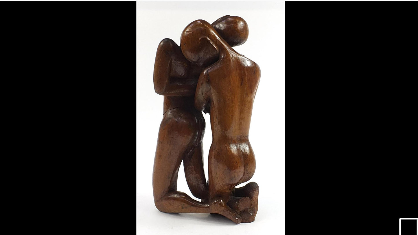 Wood carving of an embracing couple