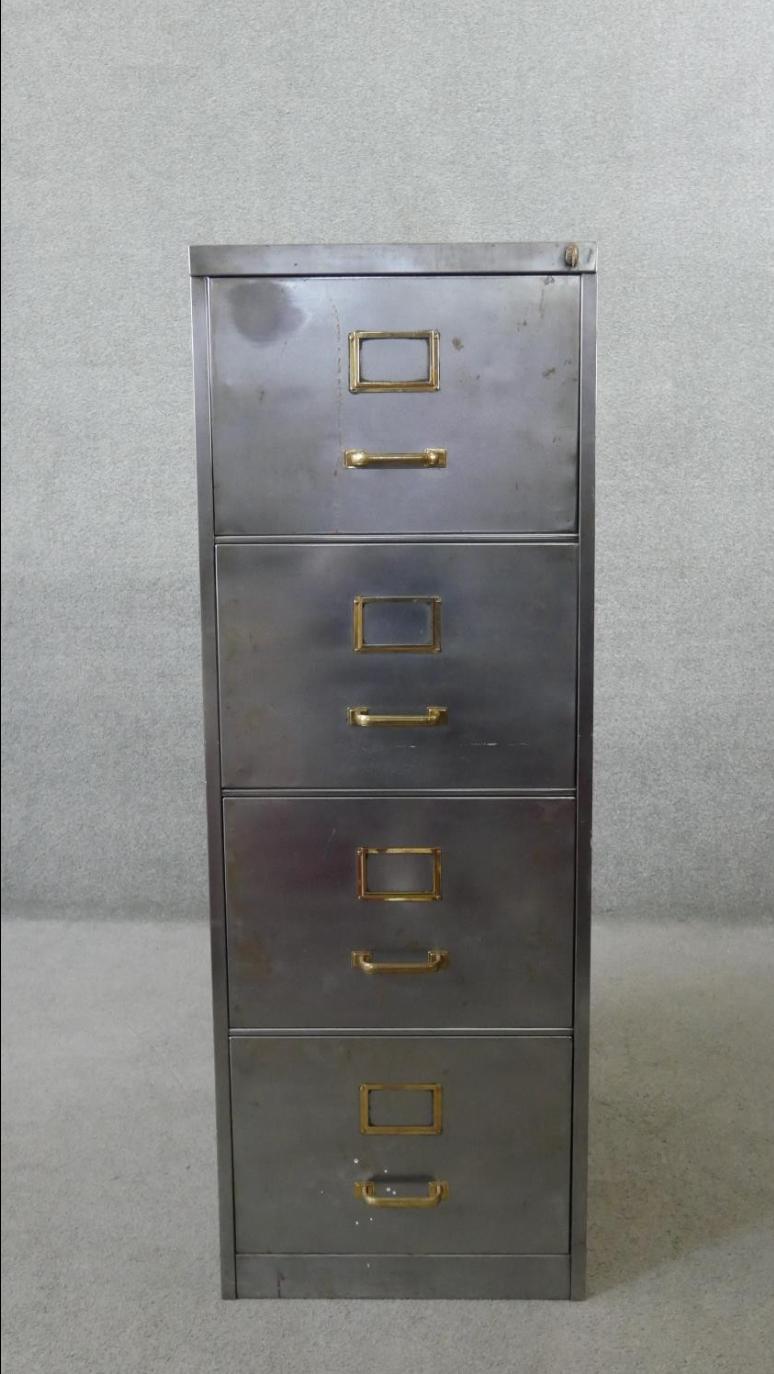 Vintage polished metal filing cabinet with brass fittings.