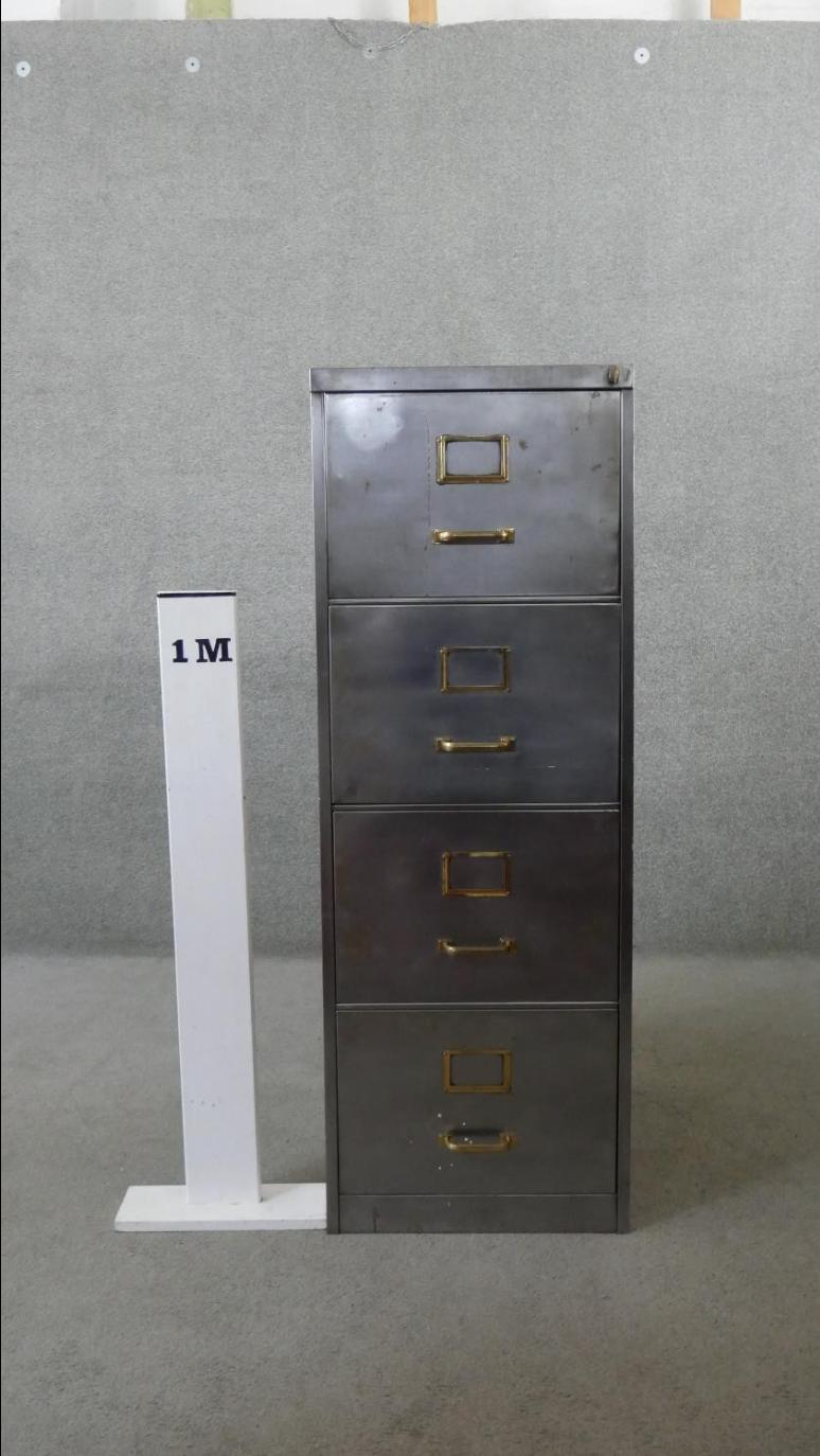 Vintage polished metal filing cabinet with brass fittings.