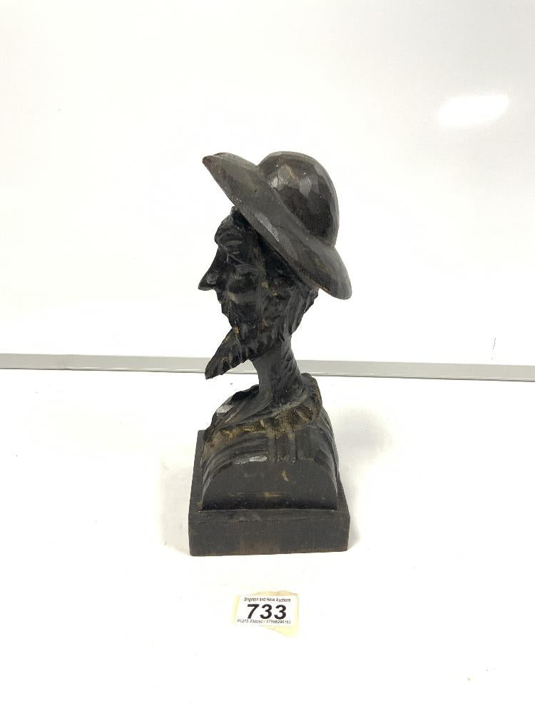 Wooden man carved with hat and beard