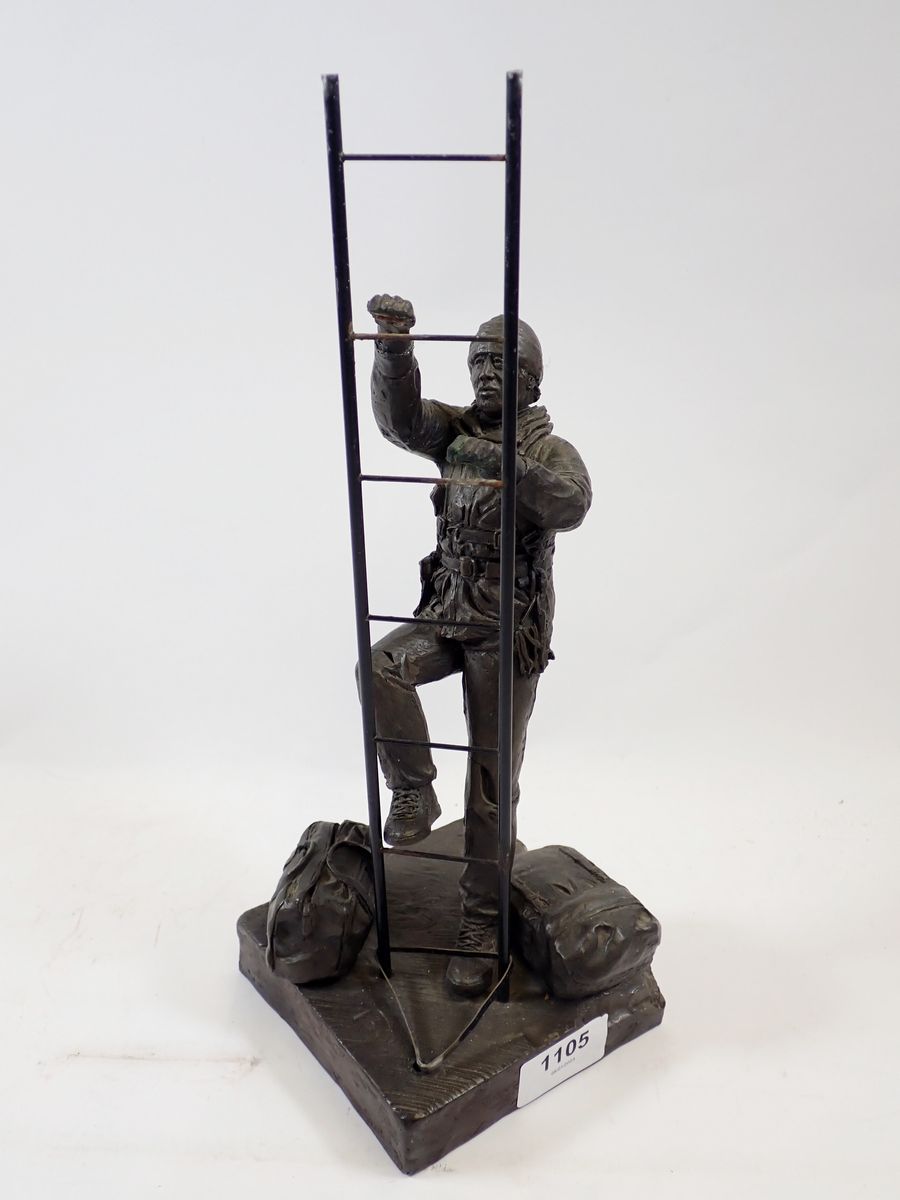 A bronze workman figure with ladder