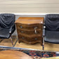 A pair of vintage armchairs in chrome steel and black leather
