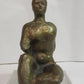 Seated woman on a perspex plinth