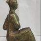 Seated woman on a perspex plinth