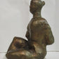 Seated woman on a perspex plinth