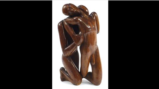 Wood carving of an embracing couple