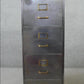 Vintage polished metal filing cabinet with brass fittings.