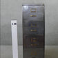 Vintage polished metal filing cabinet with brass fittings.
