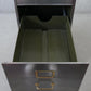 Vintage polished metal filing cabinet with brass fittings.