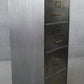 Vintage polished metal filing cabinet with brass fittings.