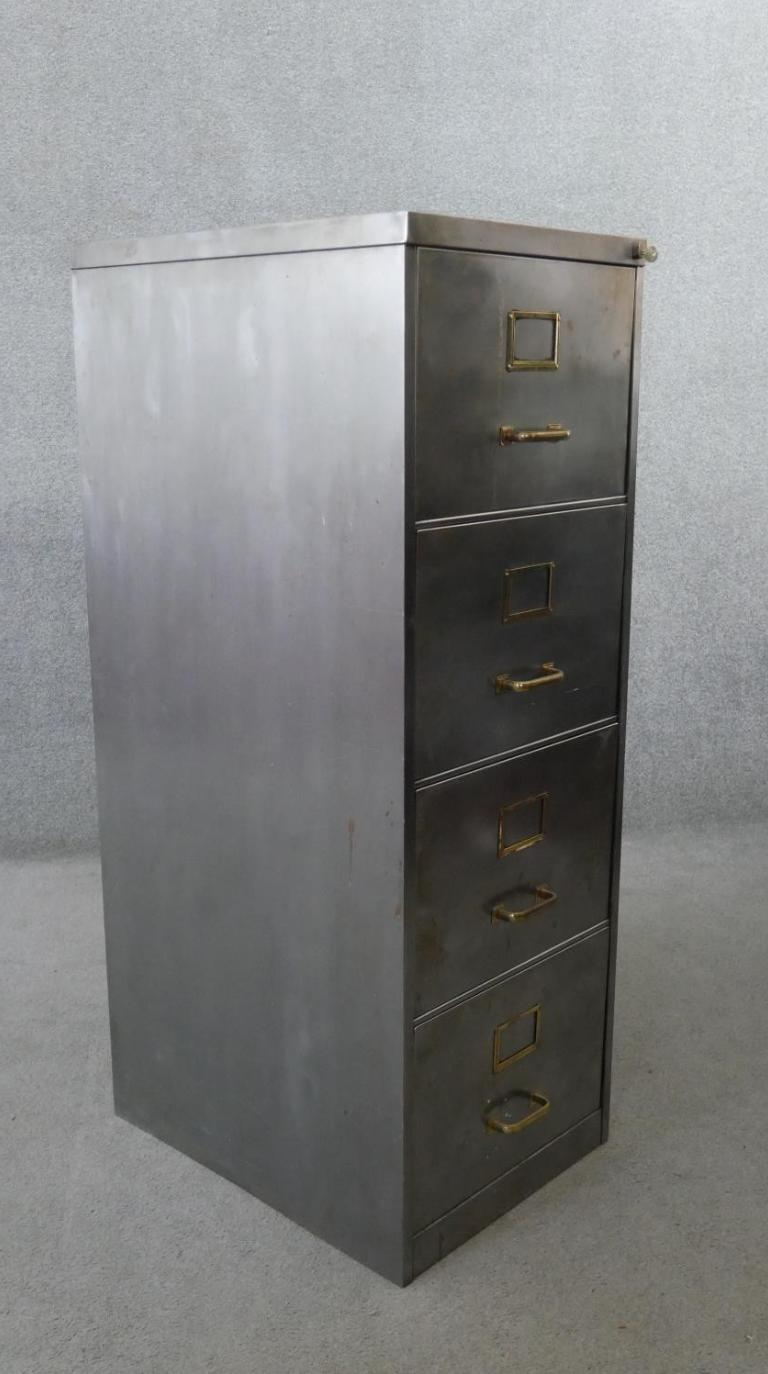 Vintage polished metal filing cabinet with brass fittings.
