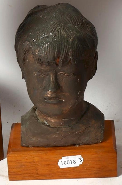 Sculptured head mounted on wooden plinth