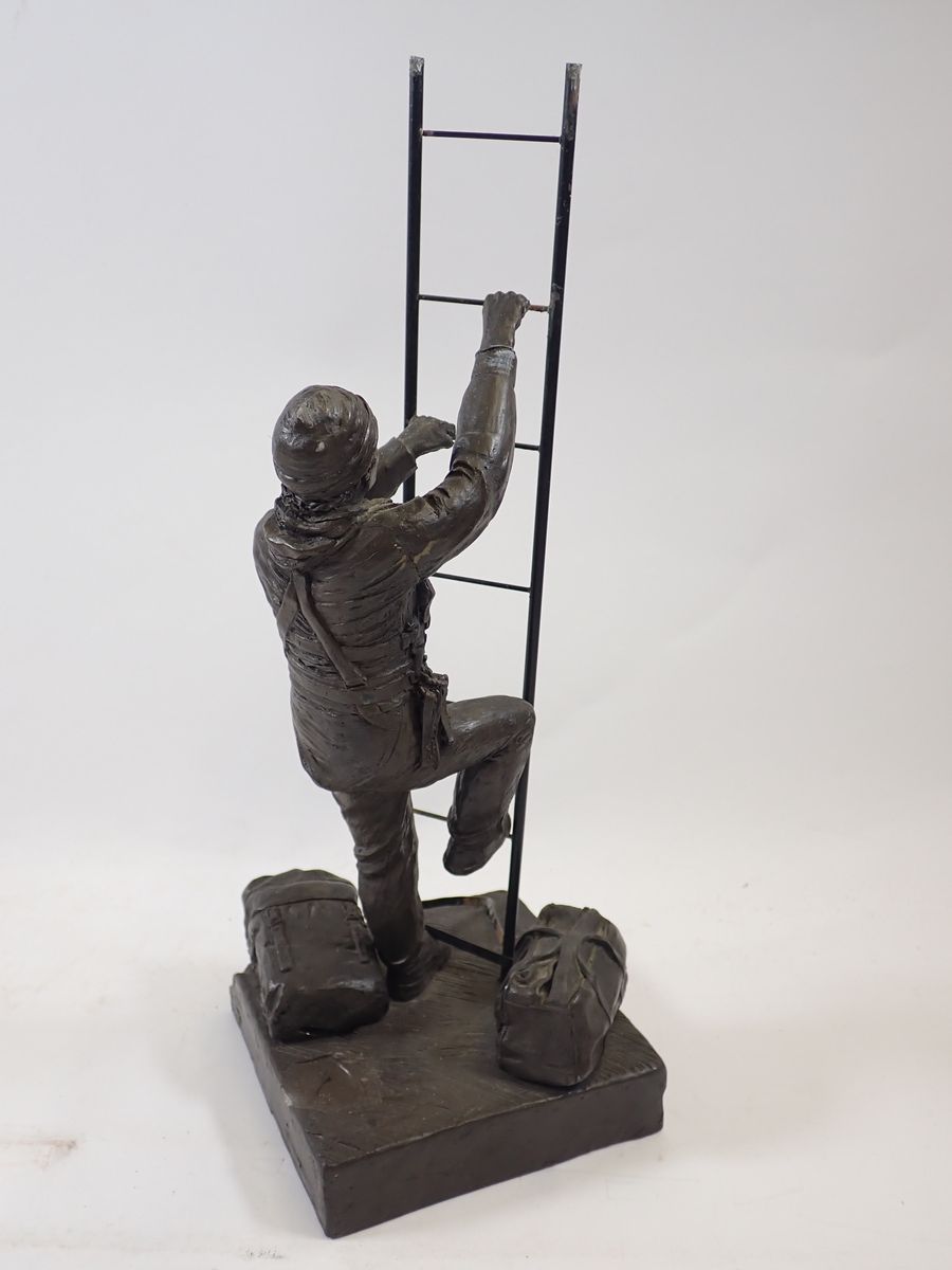 A bronze workman figure with ladder