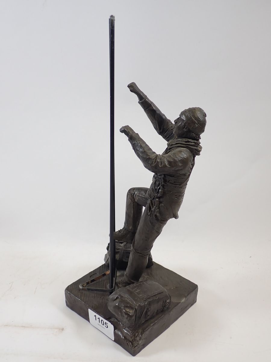 A bronze workman figure with ladder