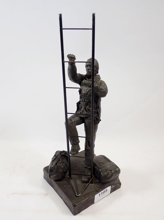 A bronze workman figure with ladder